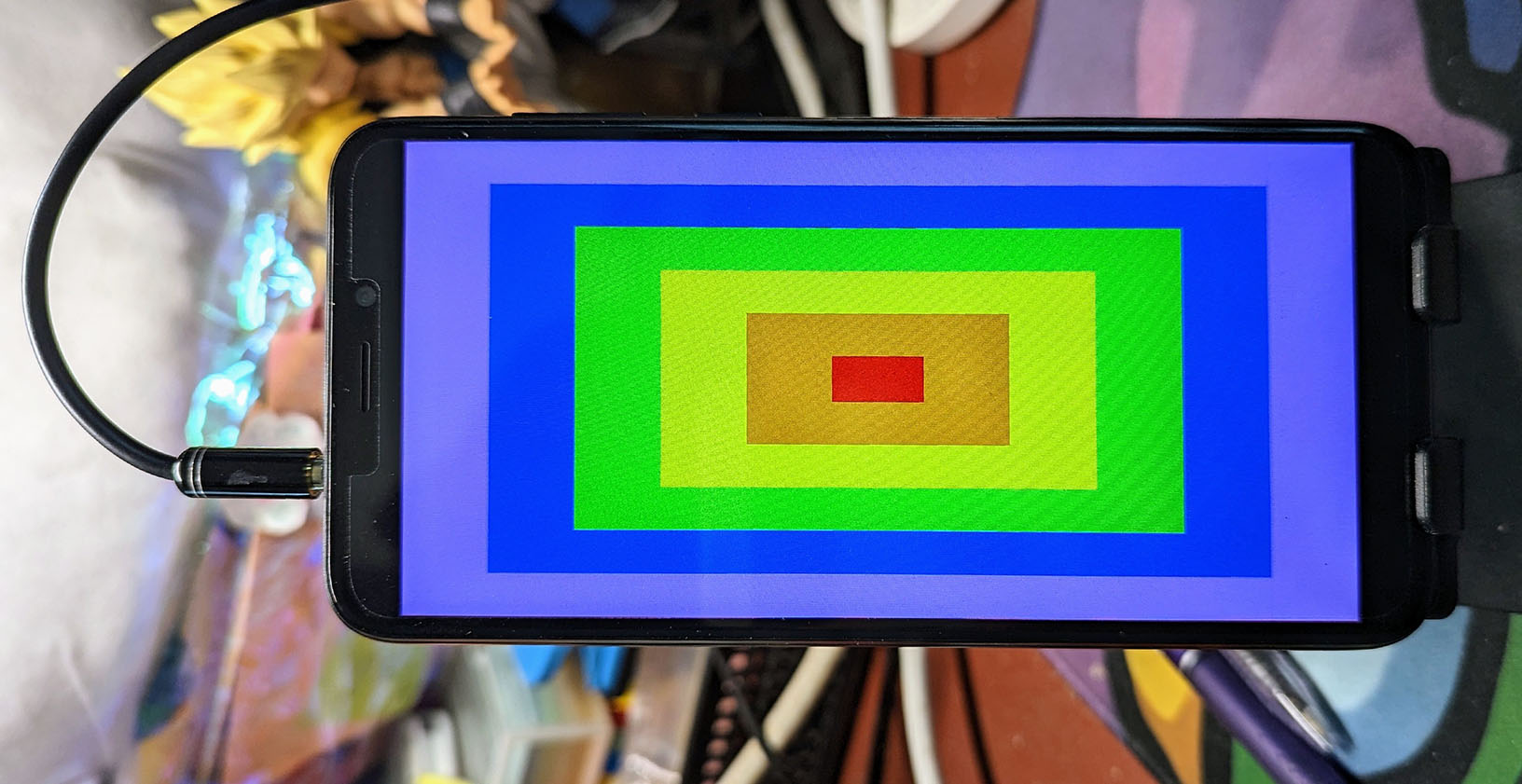 The Pinephone displaying concentric, colourful rectangles after running the ``fb`` example.