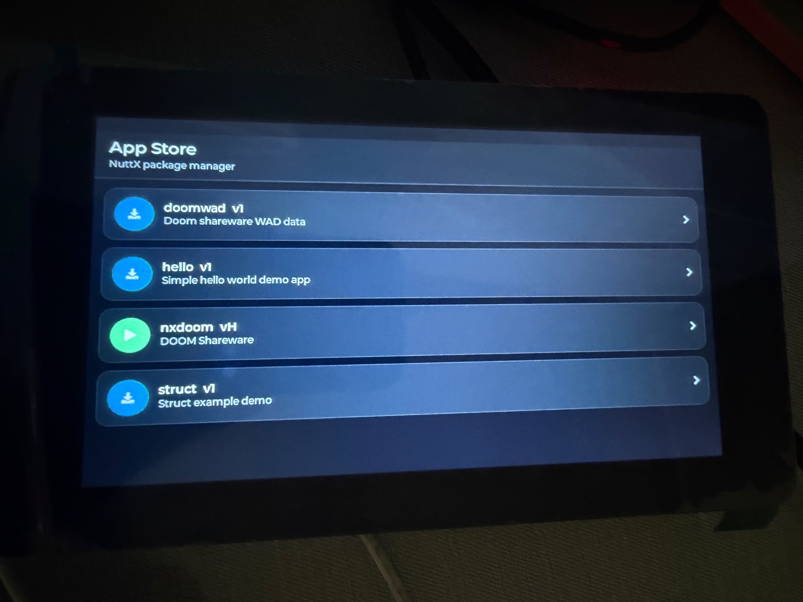 NXStore package catalog running on an ESP32-S3 touchscreen board
